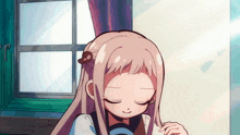 a girl with long hair is sitting in front of a window with her eyes closed .