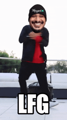a man wearing a blizzard hat is dancing in front of a couch
