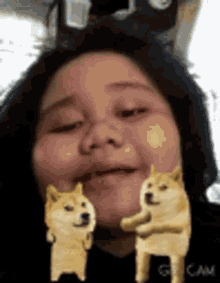 a girl is making a funny face with two doge faces on her face .