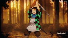 a man in a plaid shirt is holding a sword in the middle of a forest .