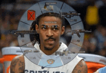a man in a grizzlies jersey has a knuckle duster on his forehead