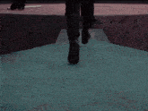 a man in a suit is kneeling down on a red surface