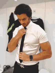 a man wearing a white shirt and a black tie has an ax belt
