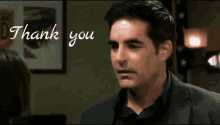 a man in a suit says thank you to a woman in a room