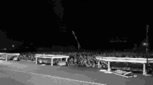 a black and white photo of a crowd at a concert .