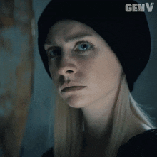 a close up of a woman wearing a black hat with genv written on it