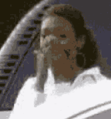a blurry picture of a man with long hair and a white shirt
