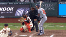 a baseball game is being played with a kook ad in the background