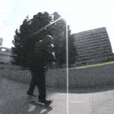 a man is riding a skateboard down a ramp in front of a building