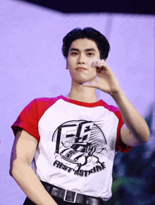 a man wearing a shirt that says fast strike on it