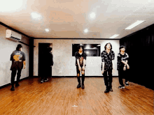 a group of young men are dancing in a room and one of them is wearing a shirt that says ' i love you '