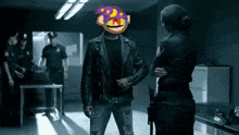 a man in a leather jacket with a monkey on his head is talking to a police officer