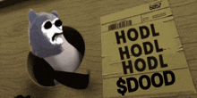 a paper that says ' hodl hodl hodl $ dood ' on it next to a stuffed animal