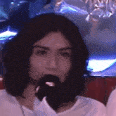 a close up of a person 's face with a microphone in their mouth