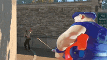 a man in a blue uniform is holding a sword in front of a sign that says sprinklers