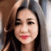 a blurry picture of a woman 's face with long hair and red lips