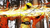 a man wearing a yellow helmet is standing in a forest with trees in the background