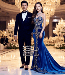 a man in a tuxedo and a woman in a blue and gold dress are standing next to each other