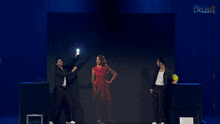 a woman in a red dress is standing in front of a screen with the word talent on it