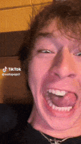 a close up of a man making a funny face with tiktok written on the bottom right