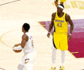 a basketball player wearing a yellow jersey with indiana 43 on it
