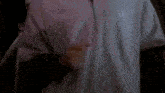 a close up of a person 's back in a dark room with a blurry background .