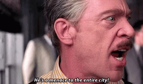 a man with a mustache is screaming and saying `` he 's a menace to the entire city ! ``