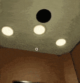 a ceiling with three lights and a circle in the middle of it