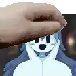 a hand is holding a piece of paper over a cartoon character 's face .