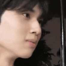 a close up of a young man 's face with his mouth open .