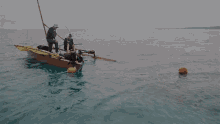 a group of people are in a boat in the water