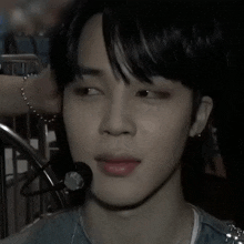 a close up of a person 's face with a microphone in his ear .