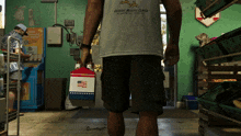 a man in a florida marine center t-shirt holds a bag