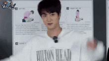 a man wearing a white shirt with the word hilton on it