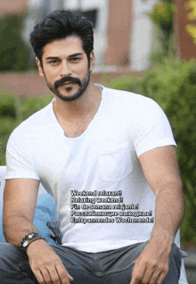 a man with a beard is wearing a white shirt