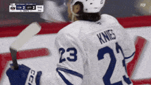 a hockey player wearing a number 23 jersey