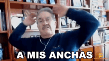a man is wearing headphones and making a funny face with the words a mis anchas written above him