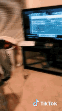 a tiktok video shows a person playing a video game on a television