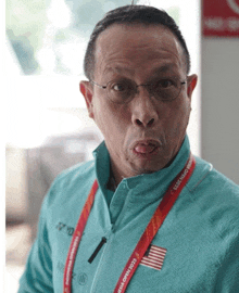 a man wearing glasses and a lanyard that says cccp world championships on it