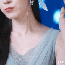 a close up of a woman 's neck with the letters ms on the bottom right