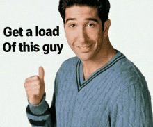 a man in a blue sweater is giving a thumbs up with the words get a load of this guy behind him