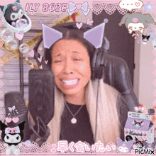 a woman wearing headphones and a cat ear headband with the words illy boze written on the top
