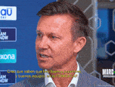 a man in a suit is talking in front of a banner that says marc personal