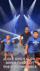 a group of young boys are dancing on a stage in front of a stage .