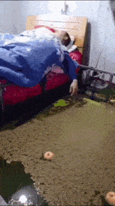 a person is laying on a bed in a room with donuts on the floor .