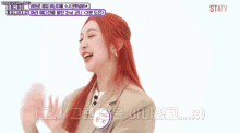 a woman with red hair is talking in a korean language
