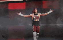 a wrestler is standing on a stage with the words " what 's up wizards " above him