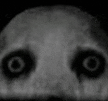 a close up of a person 's face with glowing eyes .