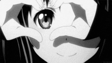 a black and white photo of a girl looking through her hands .