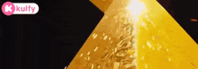a close up of a yellow pyramid with a k kulfy logo in the corner .